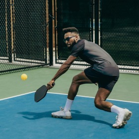 a man playing pickleball