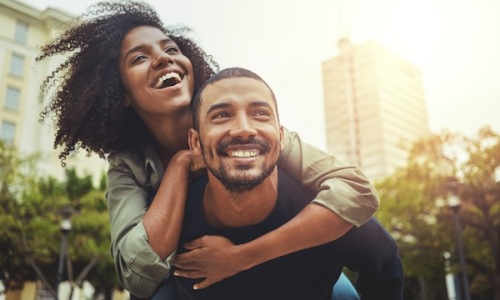 a couple laughing outdoors